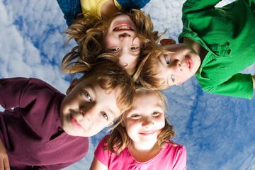 Group of children huddled up looking down