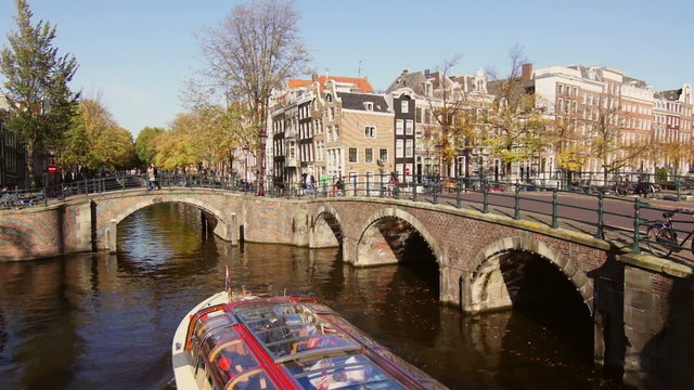Tourist boat passing through a canal in Amsterdam