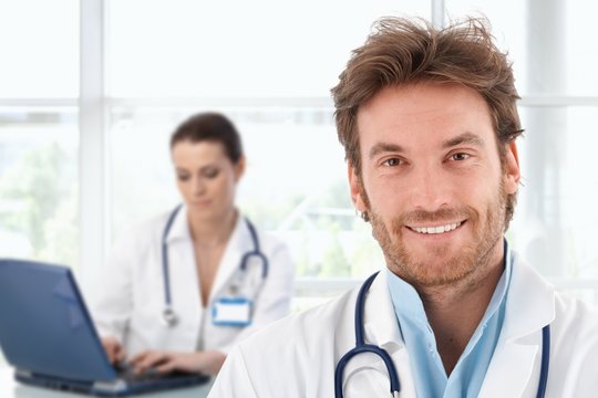 Portrait of young doctor at clinic
