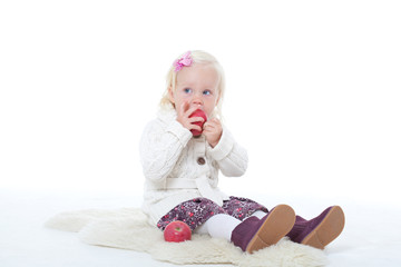 little girl in a knitted jacket on a white background