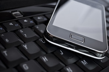 Cell phone on laptop keyboard