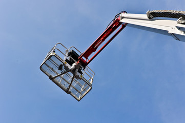 white hydraulic construction cradle against the blue sky