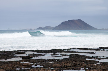 Fototapeta premium big waves (sea swell) between Fuerteventura and small island Isl