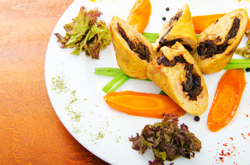 Meat and vegetable roll in plate