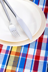 Empty plate with utensils