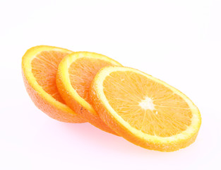 Half an Orange cut into slices on a white background