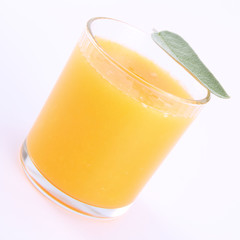 Orange juice, a glass decorated with salvia