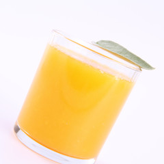 Orange juice, a glass decorated with salvia