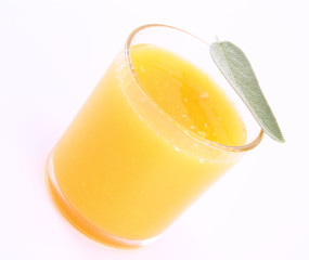 Orange juice, a glass decorated with salvia