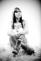 beautiful girl in ice skates sitting on floor