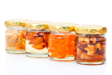 Fototapeta na wymiar honey of figs, nut, apricot canned in the jar