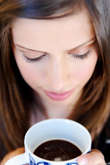 face of woman with coffee