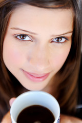 face of woman with coffee