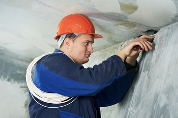 Electrician at cable wiring work