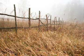 Farm fence in foggy autumn morning - 36699063