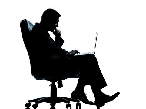 one business man computer computing sitting in armchair silhouet - Powered by Adobe