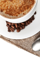 cup of hot cappuccino and coffee beans