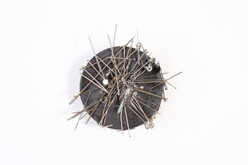 Sewing needles on a round magnet