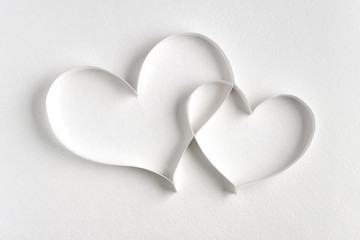 Couple of hearts made of paper on white background