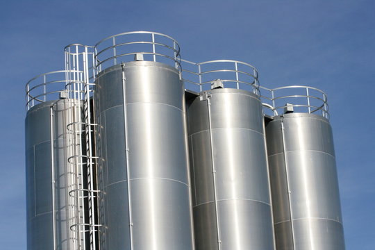 View of an industrial plant with large aluminum tanks
