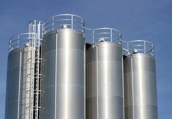 View of an industrial plant with large aluminum tanks