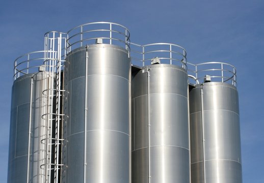 View of an industrial plant with large aluminum tanks