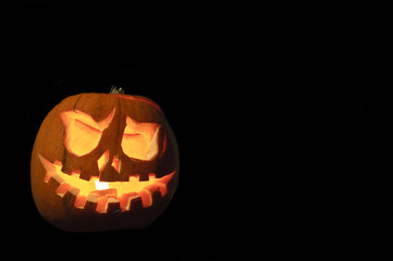 Spooky Halloween pumpkin on black background