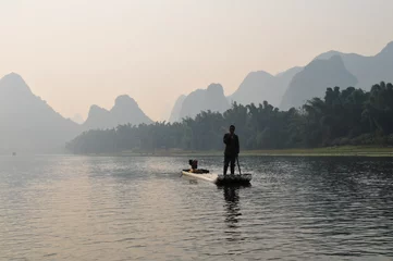 Wandcirkels plexiglas Pêcheur matinal sur la rivière Li © bobdu11