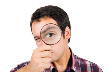 Funny image of a young man playing with a magnifying glass, isol