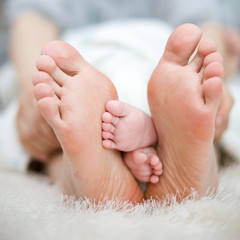 mother and baby's foot together