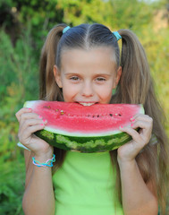 Young girl eating watermelon