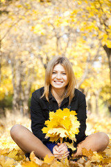 Smiling happy girl in autumn park