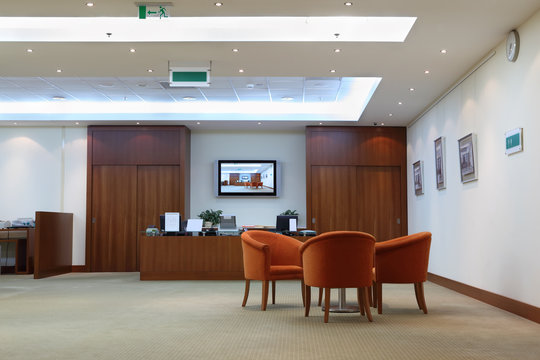 Armchairs, Table And Reception In Light, Clean And Empty Office