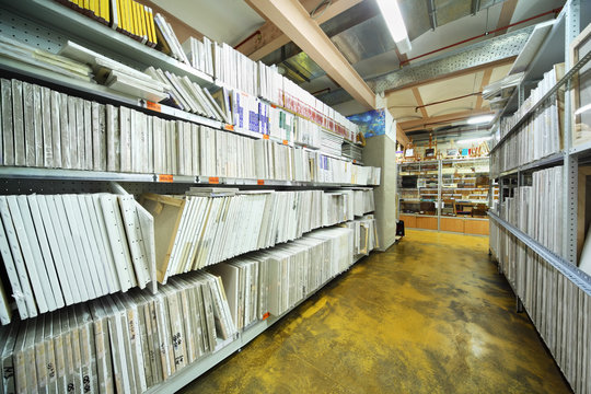 on shelves many canvases on stretchers for artists