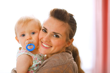 Portrait of beautiful young mother with her baby