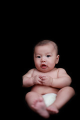 cute asian baby with black background.