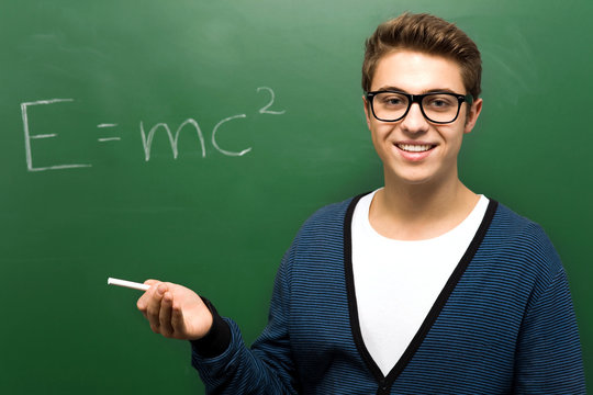 Student by chalkboard with e=mc2