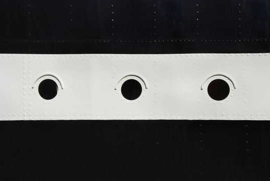 Three porthole window on a ship's hull