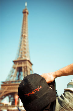 Professional photographer taking picture of eiffel tower