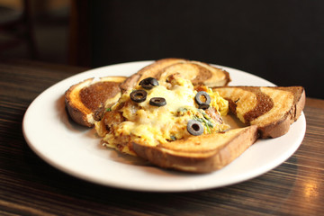 Delicious gourmet egg scramble with rye toast.