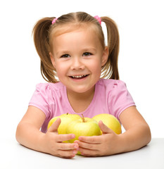 Little girl with apples