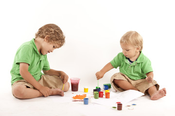 Obraz na płótnie Canvas Two boys with paints