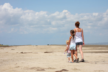 Fototapeta na wymiar mother with her children on a beach.
