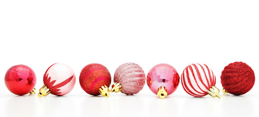 Red Christmas baubles arranged in row