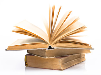 Old books piled together over white background