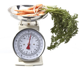 Old style kitchen scales with carrots on white background Isolat