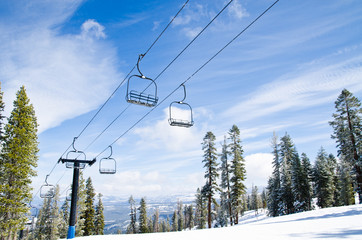 Chair lifts against the blue sky