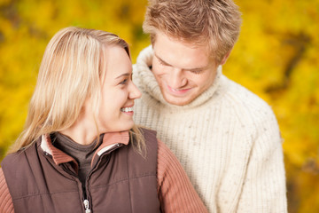Fototapeta premium Autumn happy couple hugging together in park