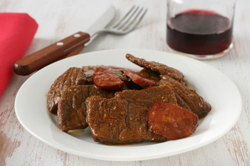 beef with sausages on plate
