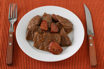 beef with sausages on plate